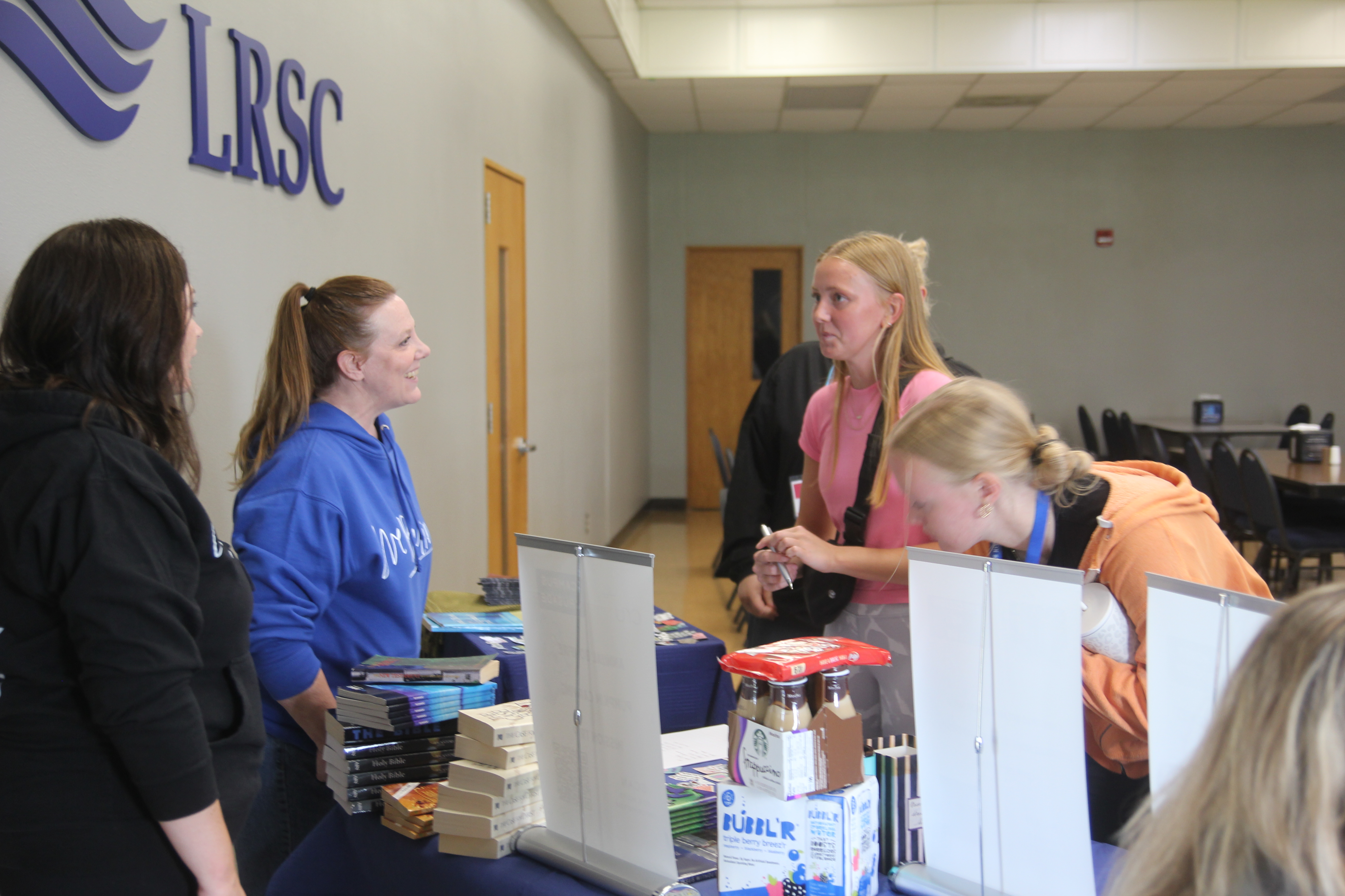 girls talking to advisors of a club.
