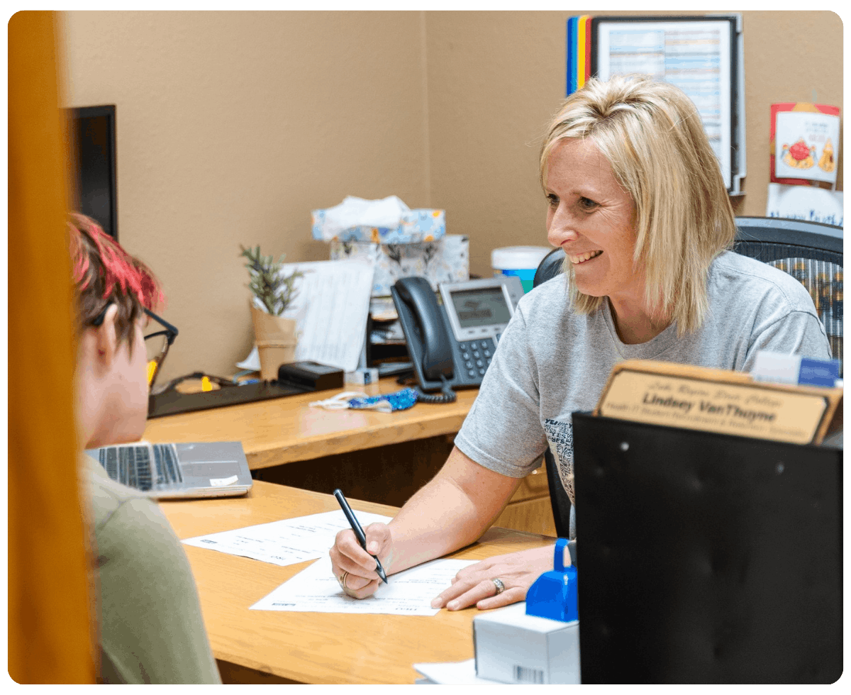 Student meeting with her advisor in the advisor's office.