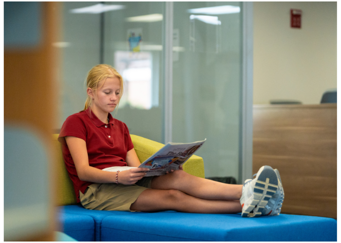 Young student reading in the Learning Commons.