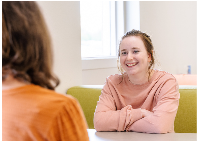 Two students talking together in the Learning Commons.