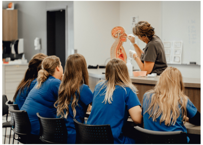 Nursing students participating in a hands-on lecture.