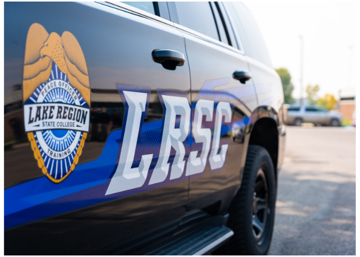 Side view of a Lake Region State College peace officer training vehicle.
