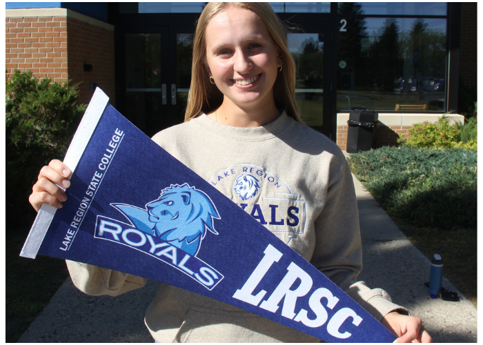 Girl holding a LRSC banner in front of the college.
