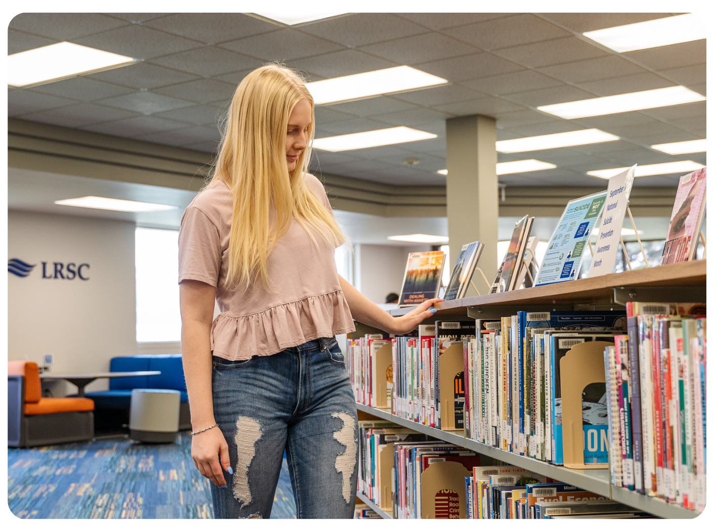 LRSC student browsing books in the campus library