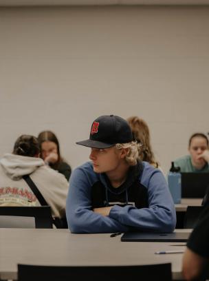 student learning in baseball cap