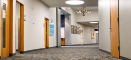 hallway with chandelier