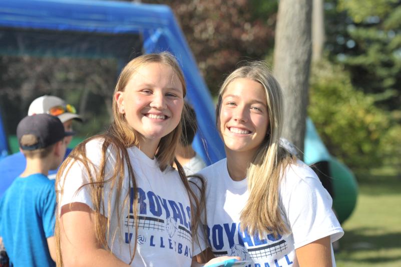 Two female co-eds pose at outdoor gathering at LRSC